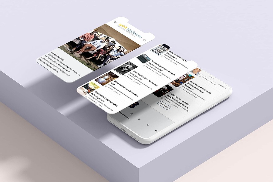 Ein Smartphone zeigt die Online-Version des BFH-Magazins «spirit biel/bienne»: Einstiegsseite und Inhaltsübersicht.